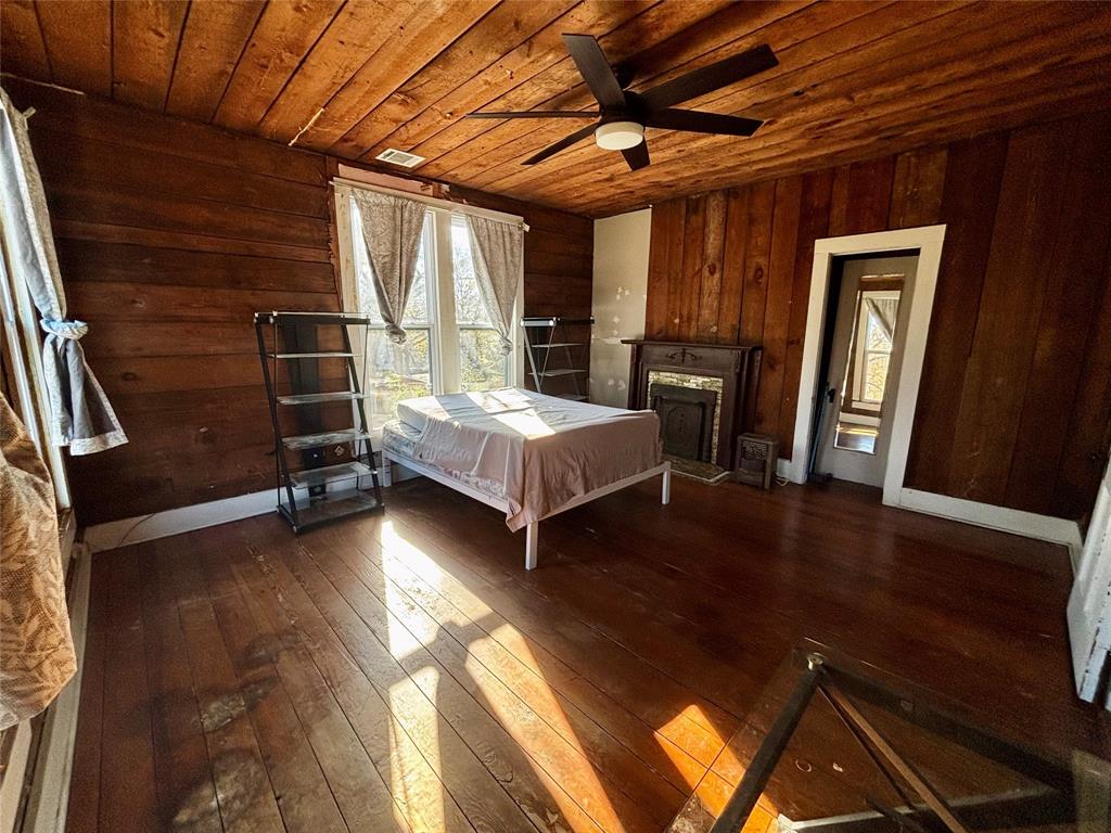 725 West 10th Street Bonham, TX 75418 - Photo 12 of 23 a room with wooden floors and furniture