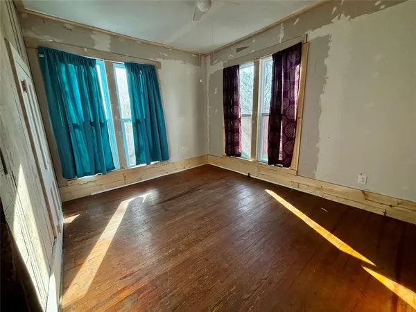 a view of a room with window and wooden floor
