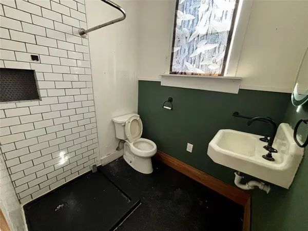 a bathroom with a toilet sink and mirror