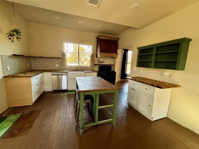 a kitchen with stainless steel appliances granite countertop a stove and a microwave