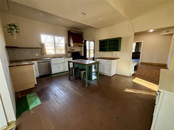 a kitchen with a sink appliances and cabinets
