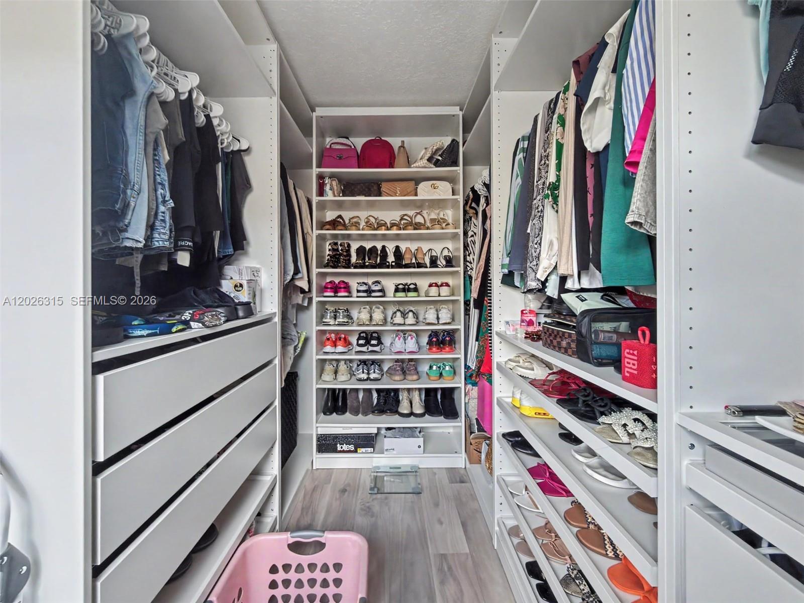 10762 Southwest 145th Street Miami, FL 33176 - Photo 16 of 28 a view of walk in closet with clothes and shoes