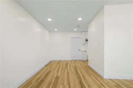 a view of a room with wooden floor and bathroom