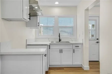 a kitchen with cabinets and window