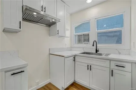 a kitchen with a sink cabinets and window