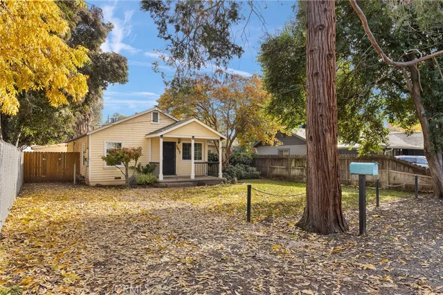 a yellow house with a yard