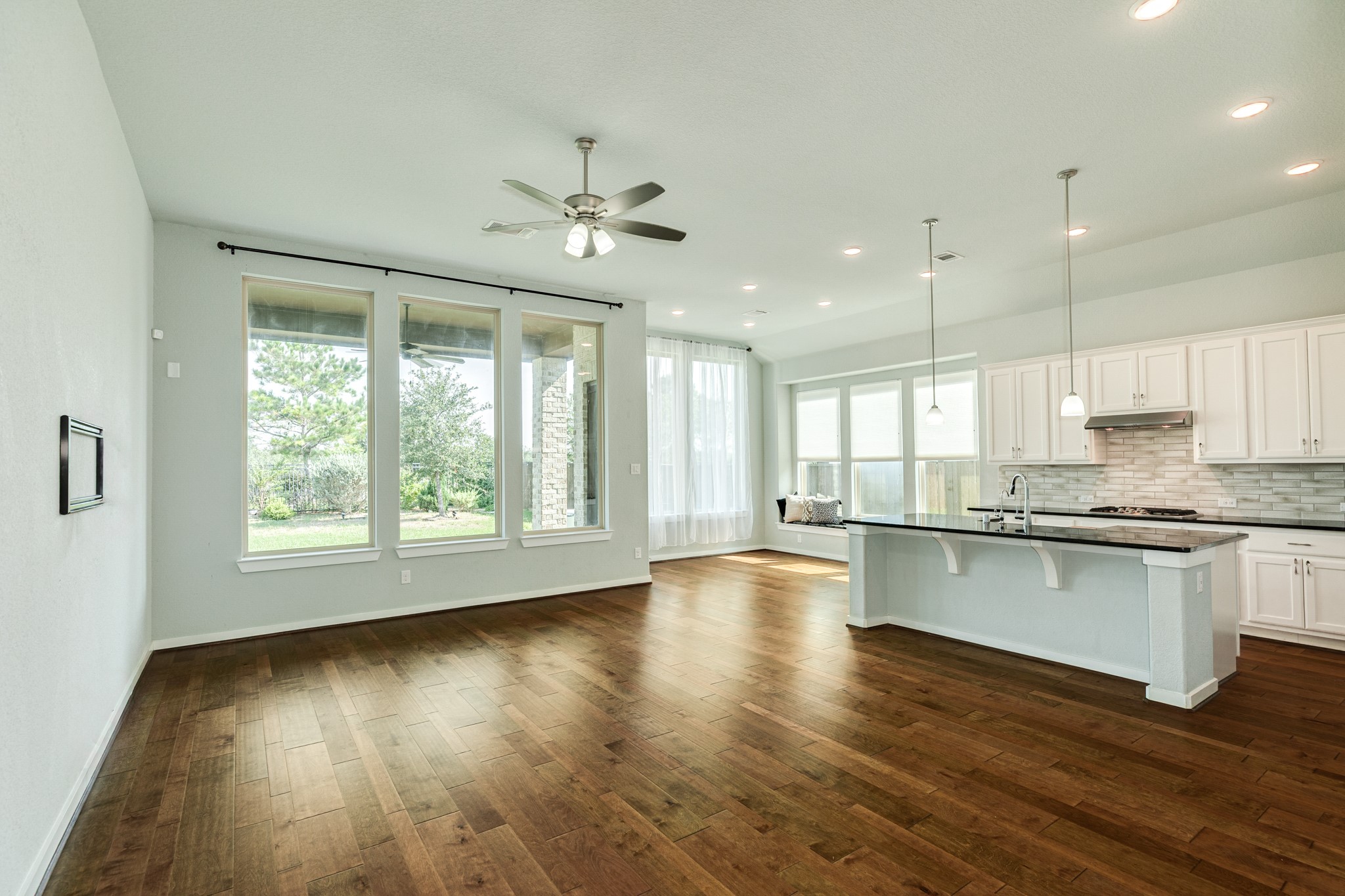 4015 Shackleton Court Iowa Colony, TX 77583 - Photo 8 of 50 The dining area features oversized windows offering scenic views of the backyard and waterfront, complemented by elegant recessed lighting.