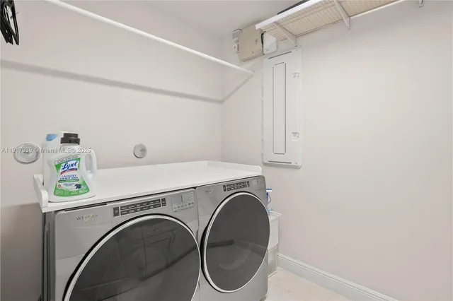 a bedroom with a bed couch and a chandelier