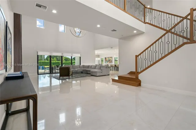 a view of a livingroom with furniture and a floor to ceiling window