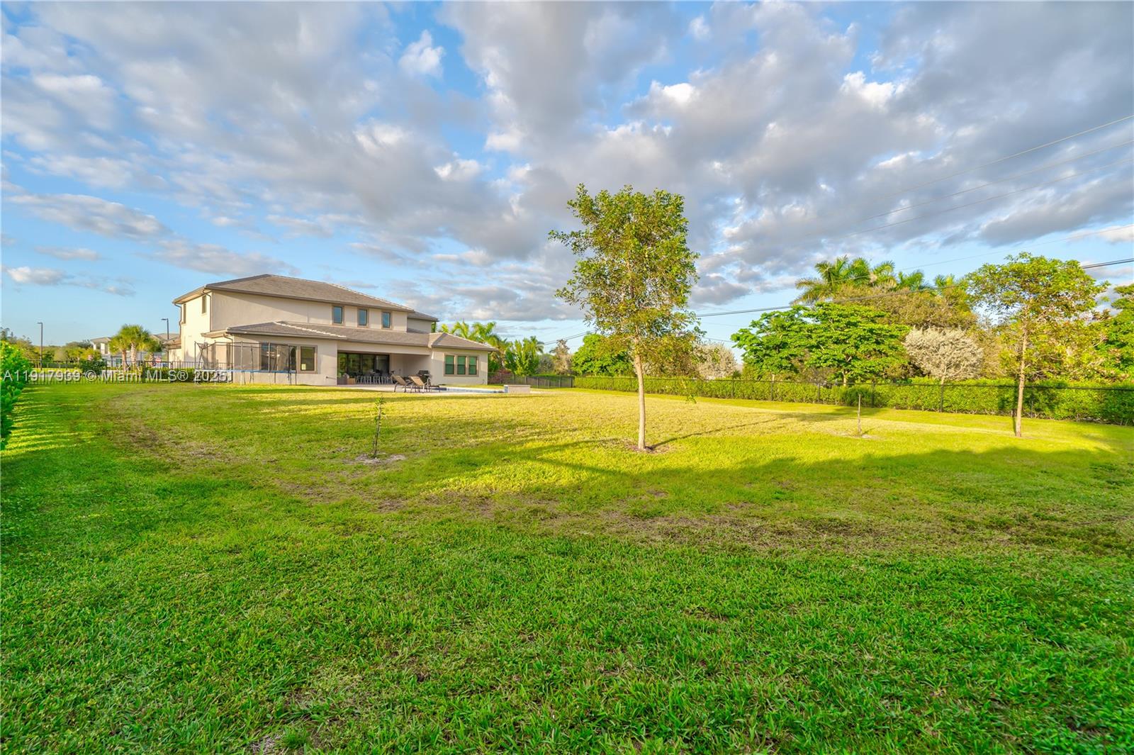 14820 Millstone Ranches Drive Davie, FL 33331 - Photo 52 of 60 a view of a house with a big yard and large trees