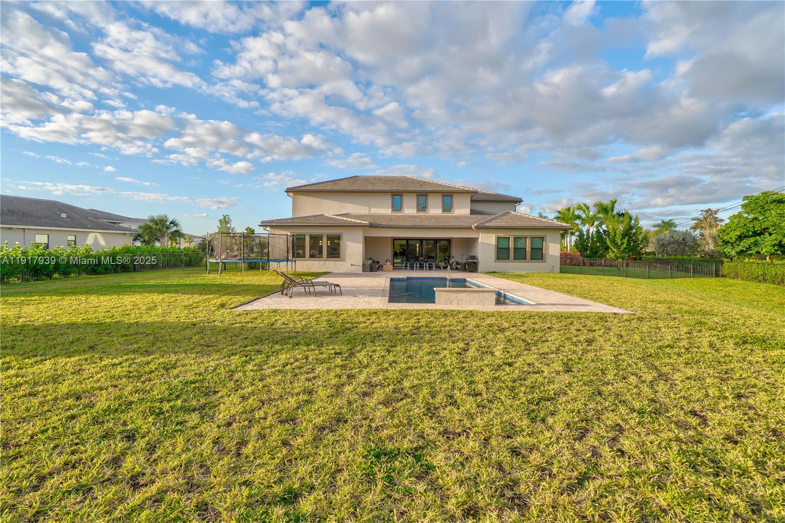 14820 Millstone Ranches Drive Davie, FL 33331 - Photo 53 of 60 a front view of a house with a yard table and chairs
