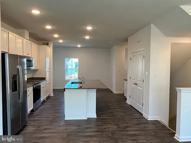 a kitchen with stainless steel appliances a refrigerator and a stove