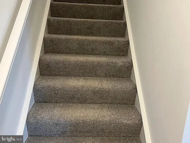 a view of staircase with white walls