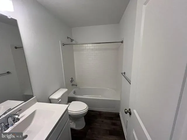 a white toilet sitting next to a bath tub