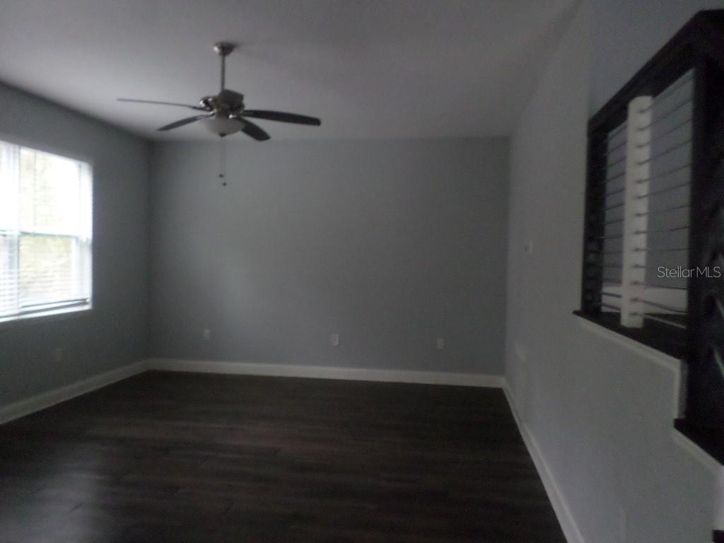 2773 Red Wing Village DeLand, FL 32720 - Photo 4 of 16 wooden floor in an empty room with a window