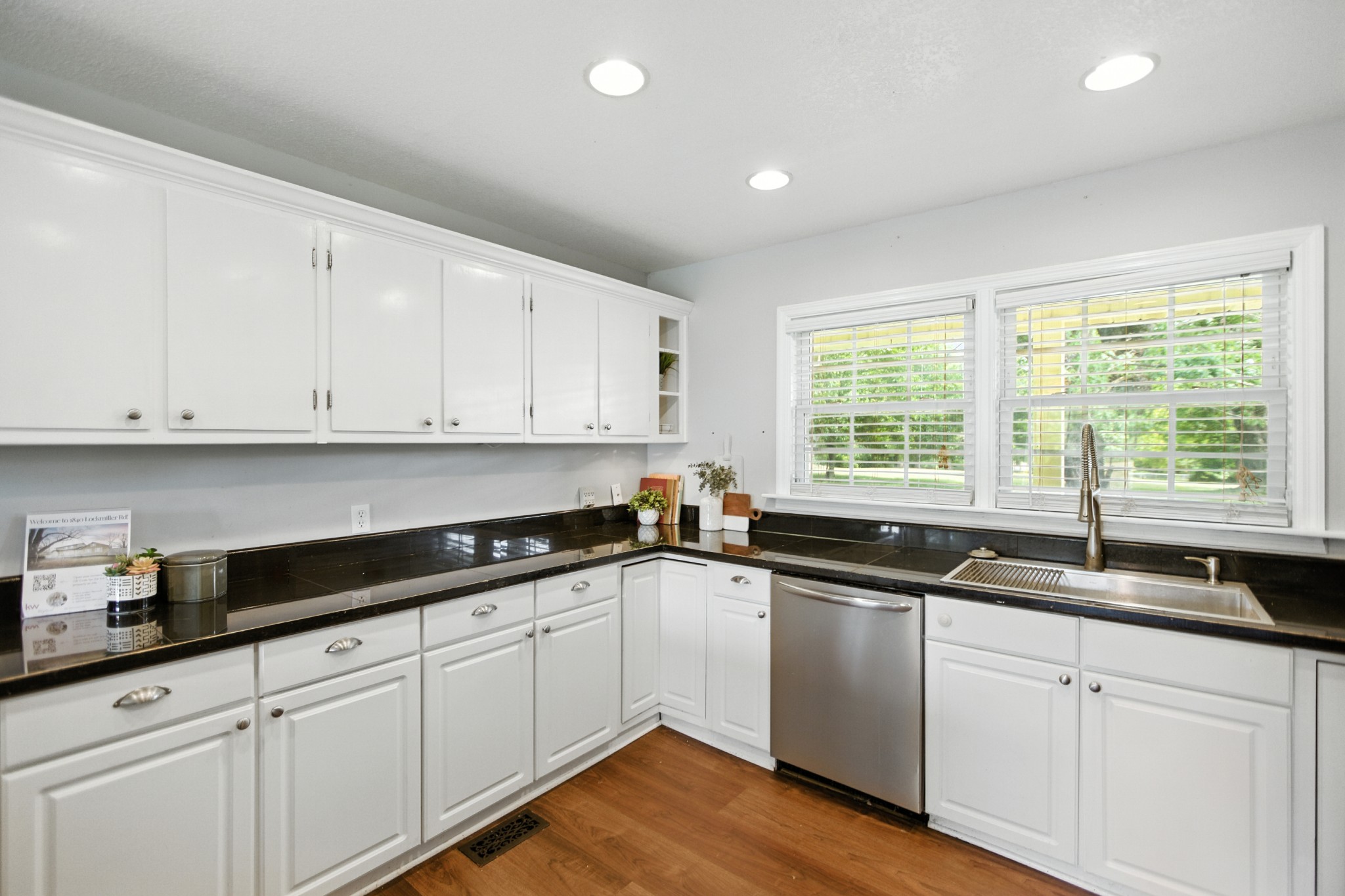 1840 Lockmiller Road Estill Springs, TN 37330 - Photo 32 of 71 a kitchen with granite countertop white cabinets white appliances a sink and a window