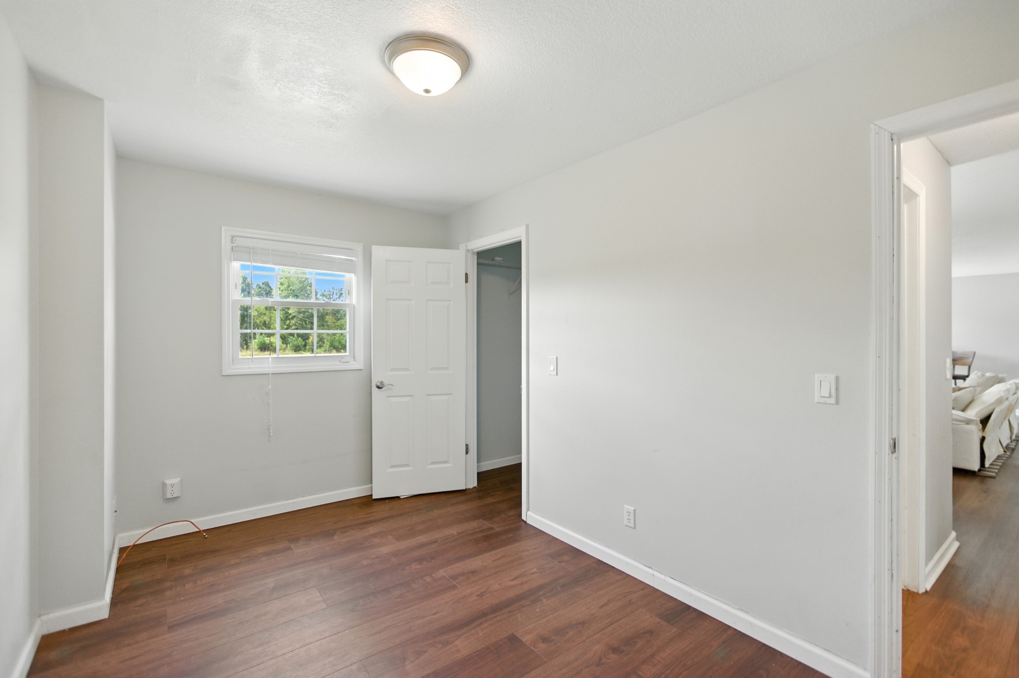 1840 Lockmiller Road Estill Springs, TN 37330 - Photo 41 of 71 an empty room with wooden floor and a bathroom