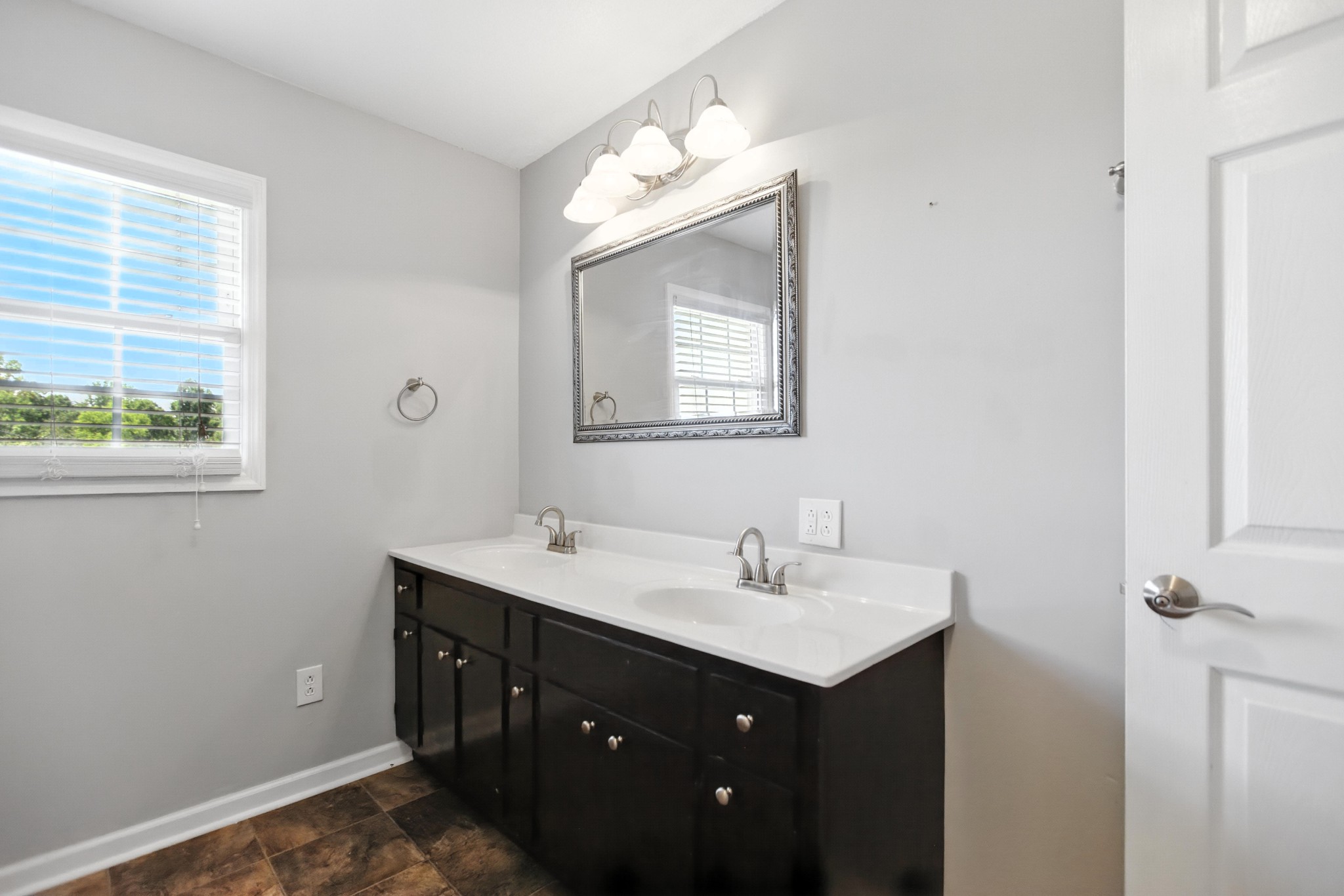 1840 Lockmiller Road Estill Springs, TN 37330 - Photo 61 of 71 a bathroom with a double vanity sink and mirror with window