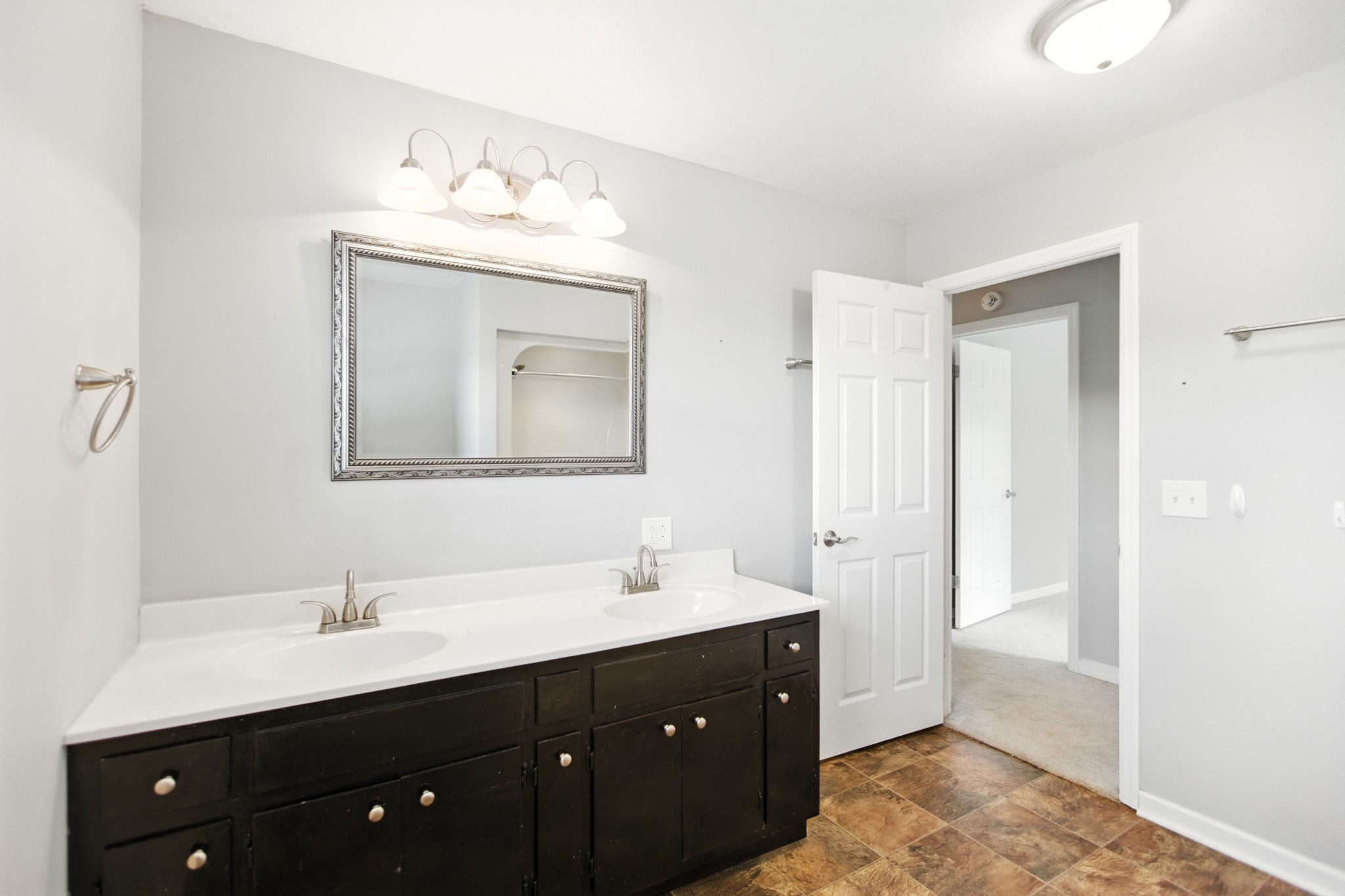 1840 Lockmiller Road Estill Springs, TN 37330 - Photo 62 of 71 a bathroom with a double vanity sink and mirror