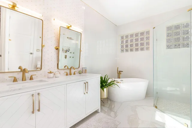 a view of a dining room with furniture a potted plant and a floor to ceiling window