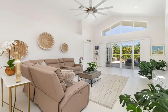 a living room with furniture and a potted plant