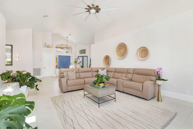 a living room with furniture and a potted plant
