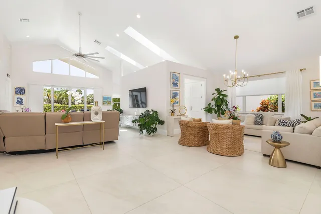 a view of a dining room with furniture a chandelier and wooden floor