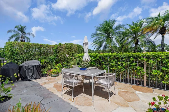 a view of a backyard with plants and a bench