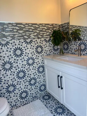 a view of a patio with dining table and chairs and potted plants