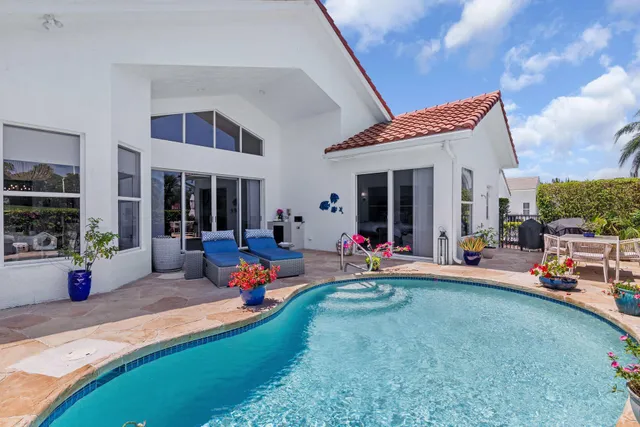 an aerial view of a houses with a yard and lake view