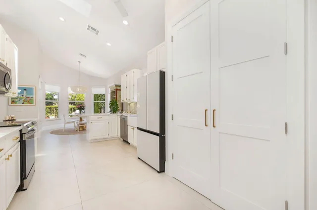 a dining room with furniture and a window