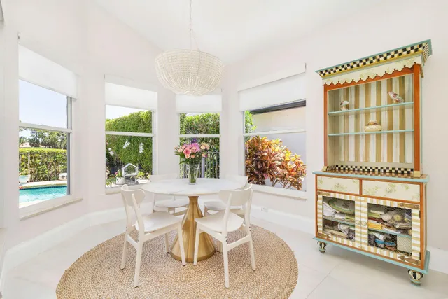a dining room with furniture a potted plant and a chandelier