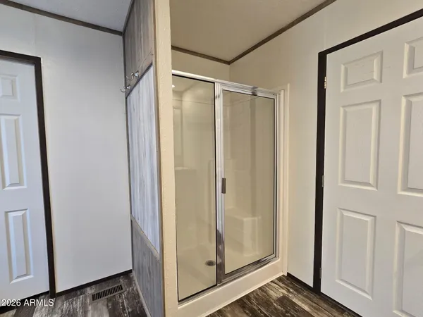 a bedroom with a bed and a chandelier