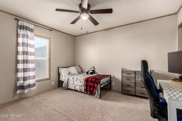 a bedroom with a workspace