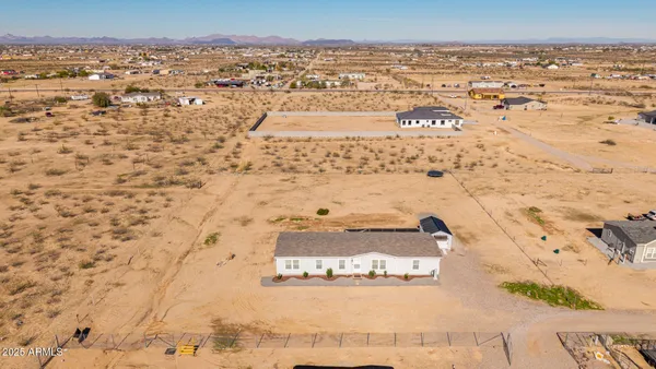 an aerial view of residential houses with outdoor space