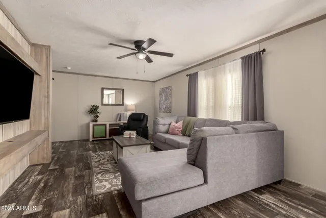 a living room with furniture a ceiling fan and a window