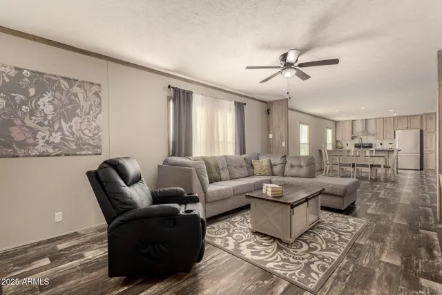 a living room with furniture and large windows