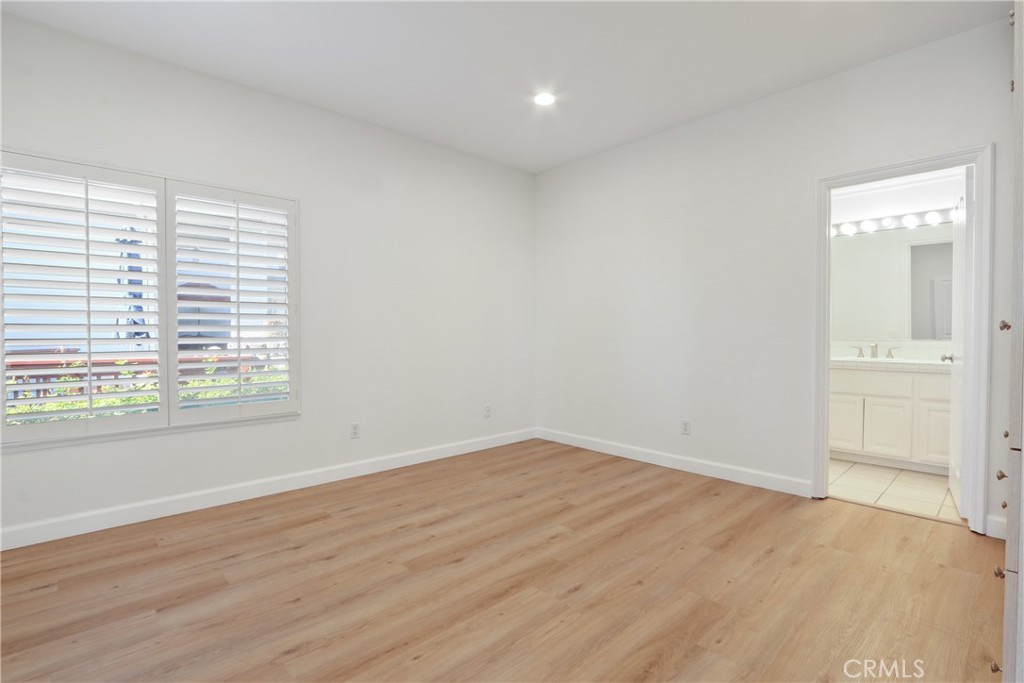 34152 Cambridge Road Dana Point, CA 92629 - Photo 11 of 25 an empty room with wooden floor and windows