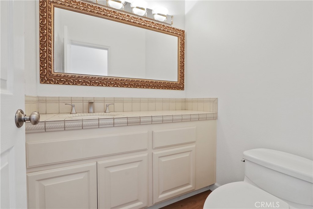 34152 Cambridge Road Dana Point, CA 92629 - Photo 14 of 25 a bathroom with a toilet sink and mirror