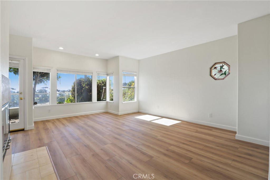 34152 Cambridge Road Dana Point, CA 92629 - Photo 16 of 25 a view of an empty room with wooden floor and a window