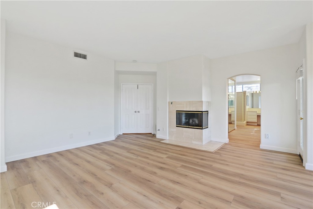 34152 Cambridge Road Dana Point, CA 92629 - Photo 17 of 25 a view of an empty room with wooden floor and a window