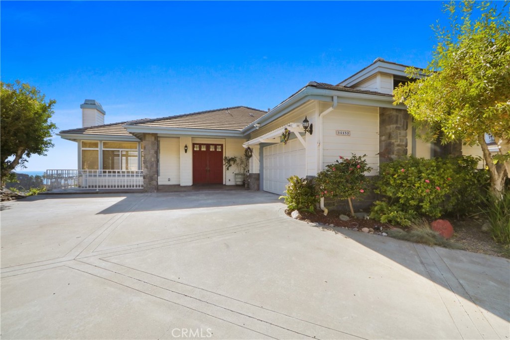 34152 Cambridge Road Dana Point, CA 92629 - Photo 2 of 25 a front view of a house with a garden