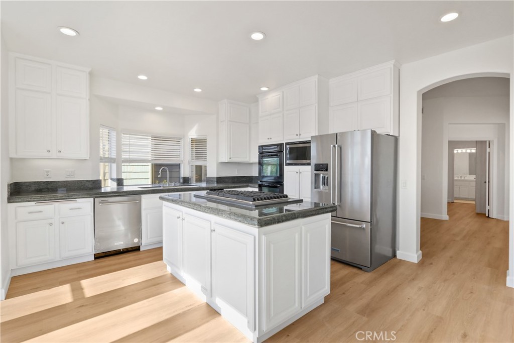 34152 Cambridge Road Dana Point, CA 92629 - Photo 7 of 25 a kitchen with stainless steel appliances granite countertop a refrigerator and a stove top oven