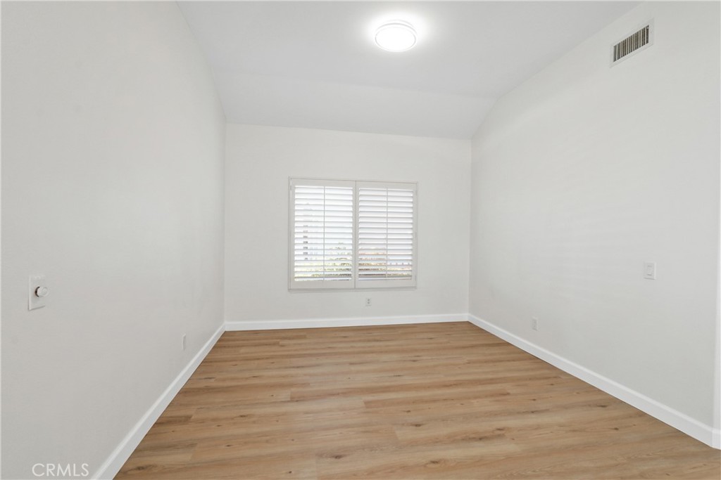 34152 Cambridge Road Dana Point, CA 92629 - Photo 9 of 25 a view of an empty room with wooden floor and a window