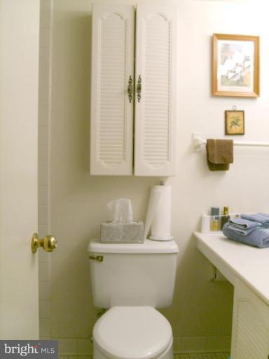 1001 26th Street Northwest, Unit 804 Washington, DC 20037 - Photo 3 of 7 a bathroom with a toilet sink and mirror