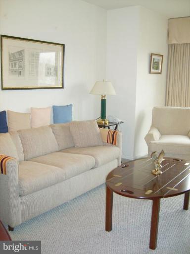 1001 26th Street Northwest, Unit 804 Washington, DC 20037 - Photo 4 of 7 a living room with furniture and a table