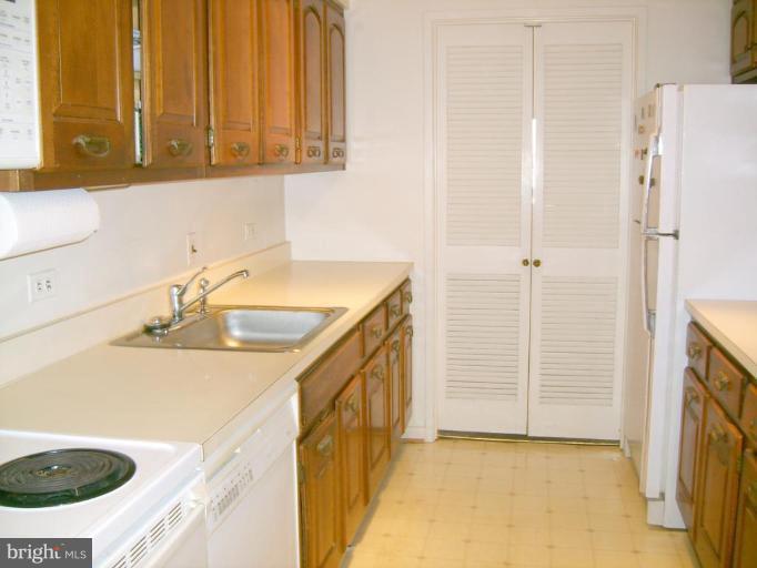 1001 26th Street Northwest, Unit 804 Washington, DC 20037 - Photo 6 of 7 a kitchen with a sink and a refrigerator