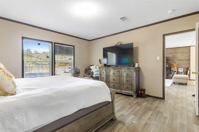 a bedroom with a bed and a flat screen tv