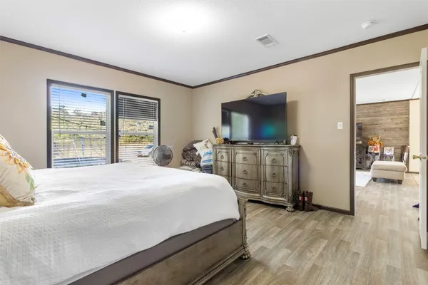 a bedroom with a bed and a flat screen tv