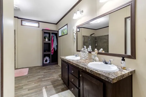 a bathroom with a sink double vanity and a mirror